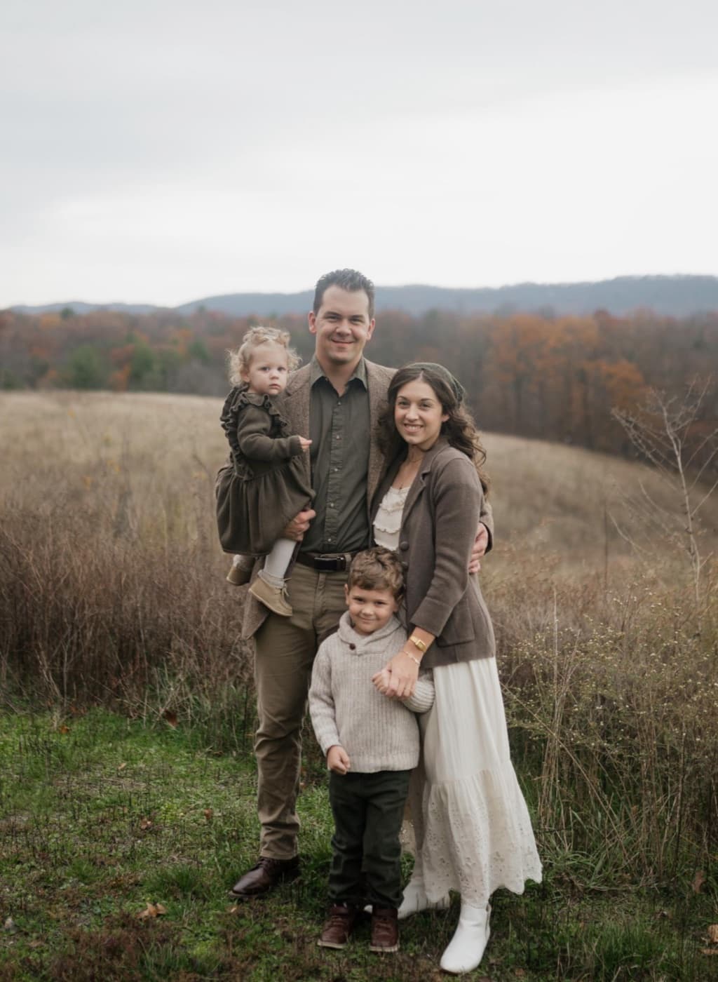 Nevada Eby with his family in a tree-lined field