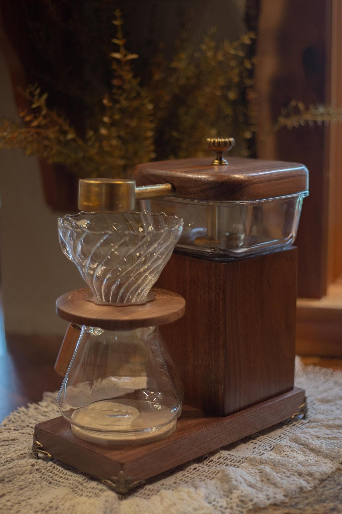The Heritage Drip in full — walnut water tower with brass scoop, swirled glass brew cone in its walnut collar, and glass carafe on the footed walnut base